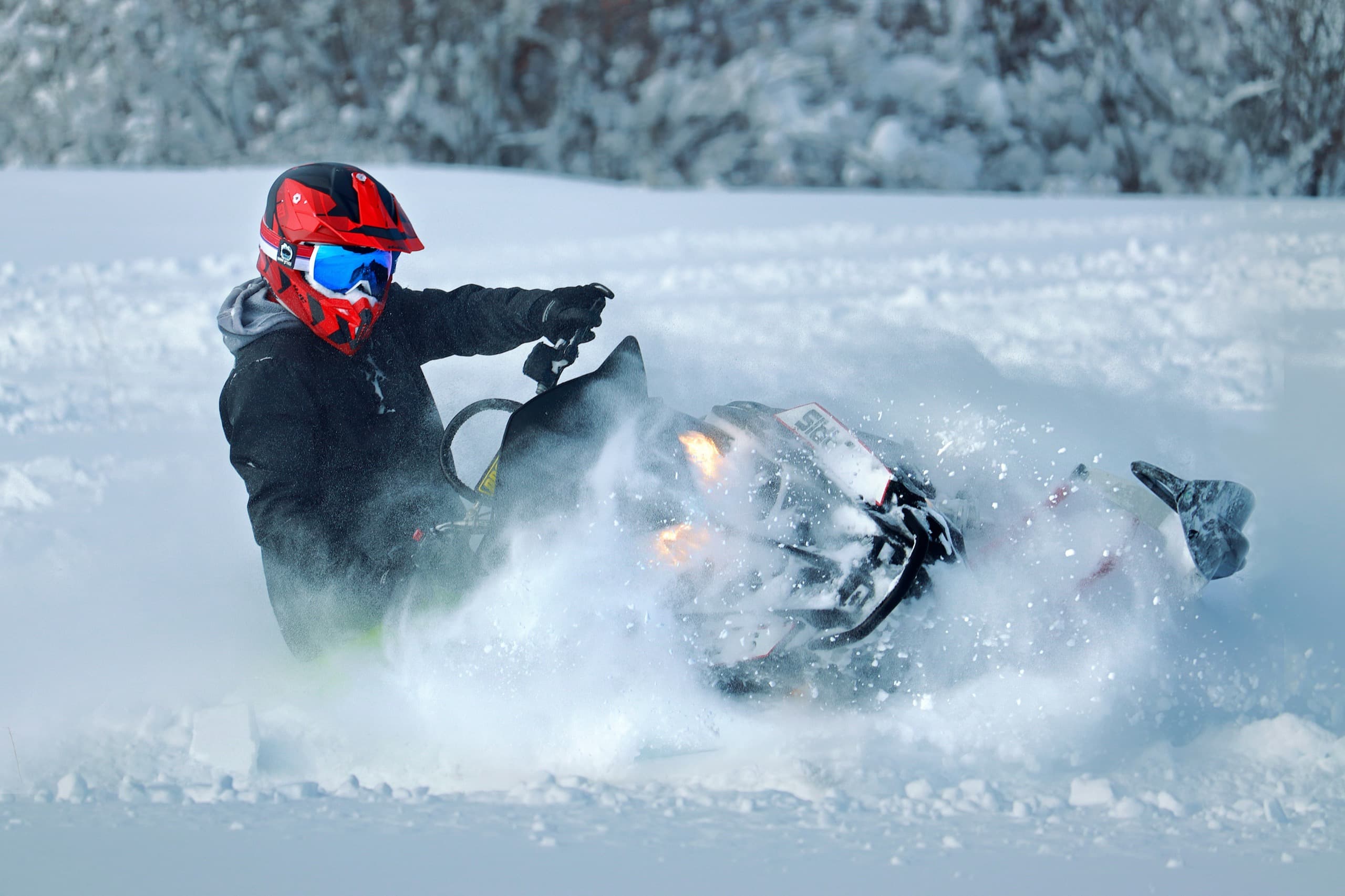 Motorcyclist putting on black gloves while seated on a bike